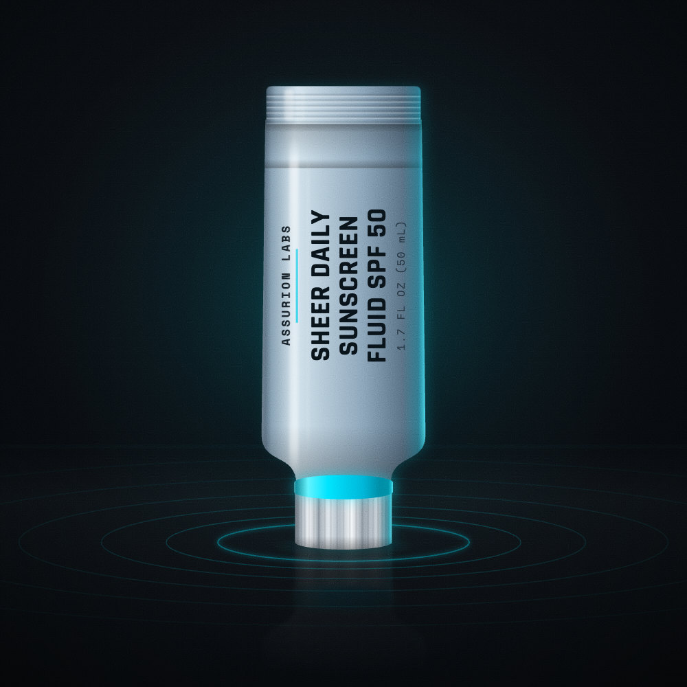 Slim frosted tube of Assurion Labs Sheer Daily Sunscreen Fluid SPF 50 on a dark background